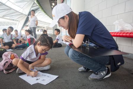 Journey educators Ms Kenix Loh, a Toyota volunteer engaging with a student during the learning journey